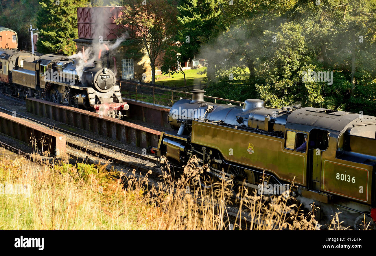 Steam trains meeting at Goathland's bridge 27 on the North Yorkshire Moors Railway. Stock Photo