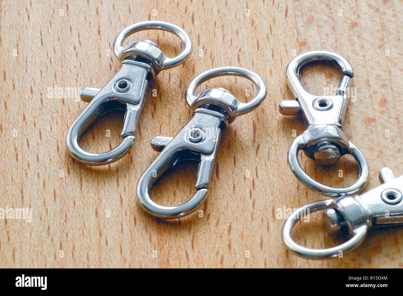 Carabiner for keys. Keychain with ring on wooden surface Stock Photo