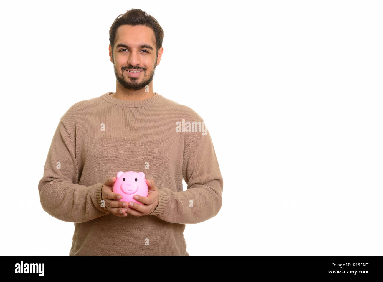 Young happy Indian man holding piggy bank Stock Photo - Alamy