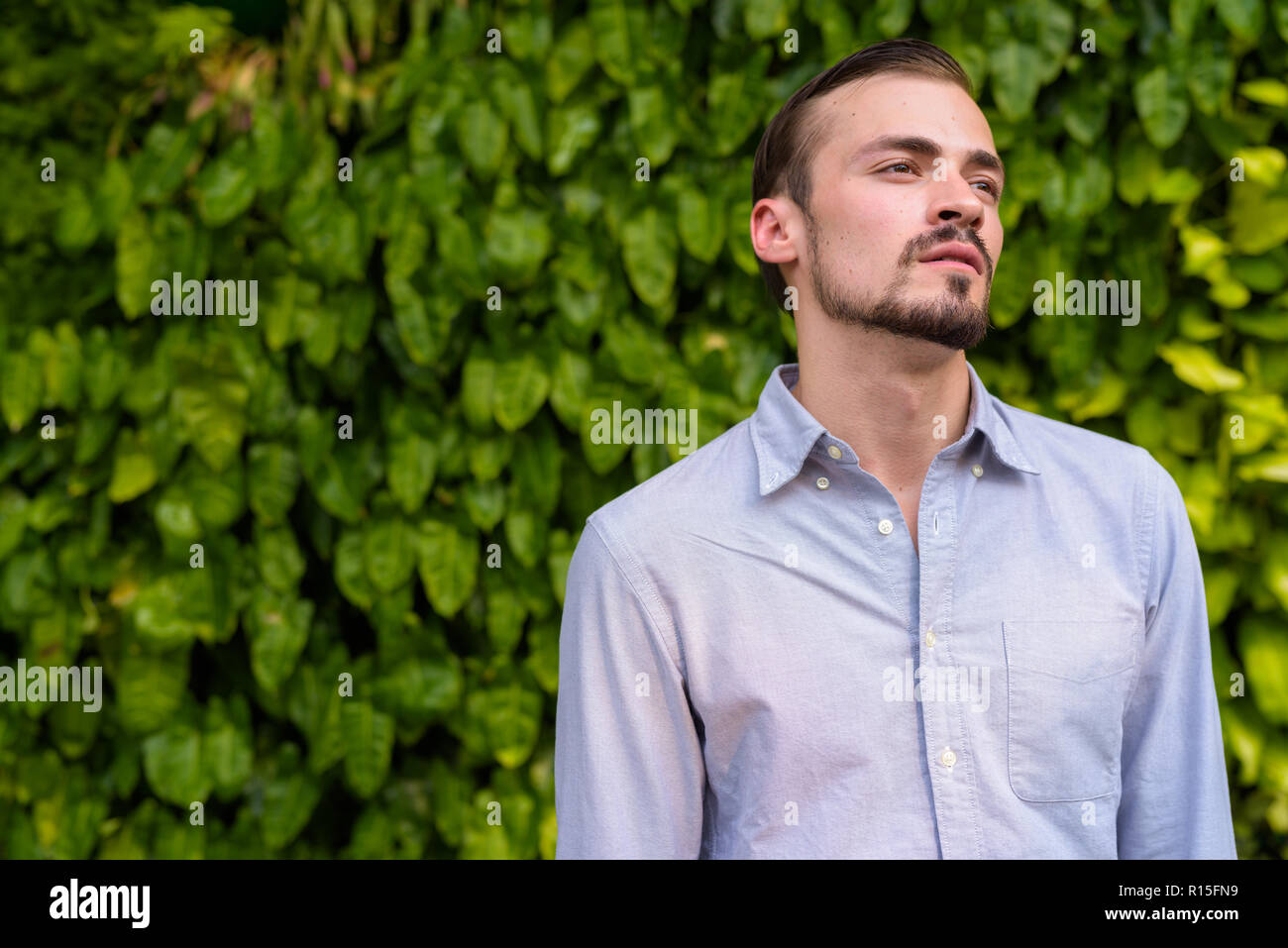 Portrait of young bearded fashionable man outdoors Stock Photo