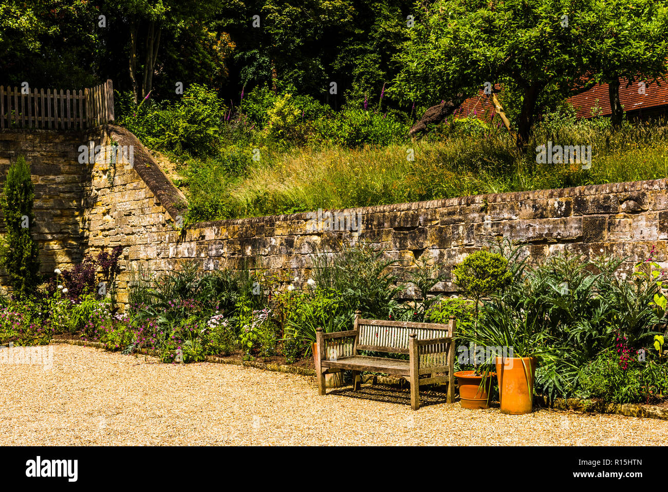 Empty bench on a summer day at Standen House, Sussex, UK Stock Photo