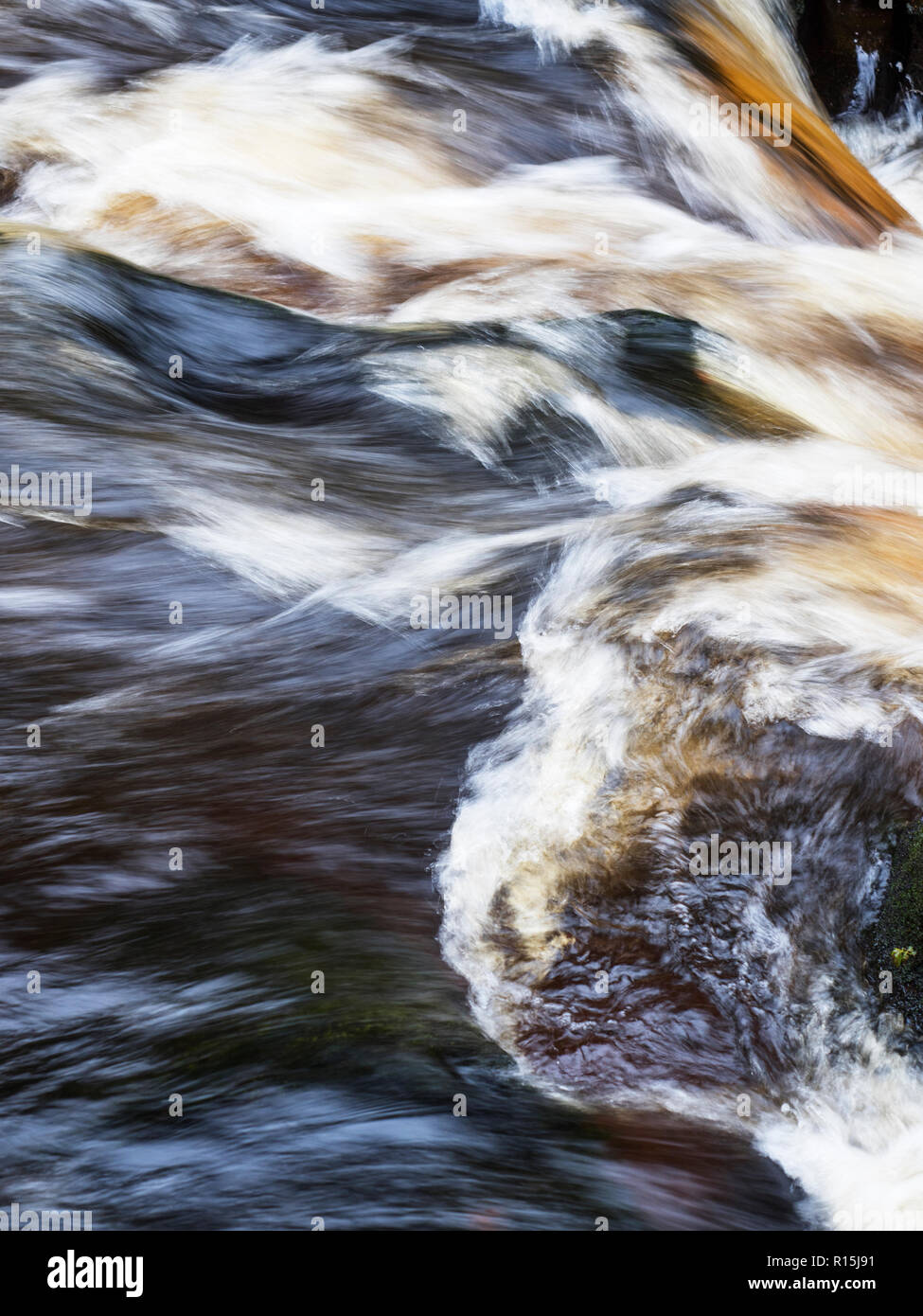 Fast flowing water in the narrow constriction of The Strid on the River Wharfe at Bolton Abbey Yorkshire Dales England Stock Photo