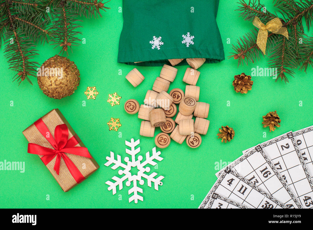 Board game lotto. Wooden lotto barrels with bag and game cards for a game  in lotto, Christmas fir tree branches, cones, toy ball, snowflackes and  gift Stock Photo - Alamy