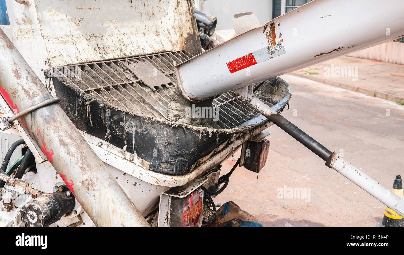 Dumping concrete from the concrete mixer truck to the pump truck
