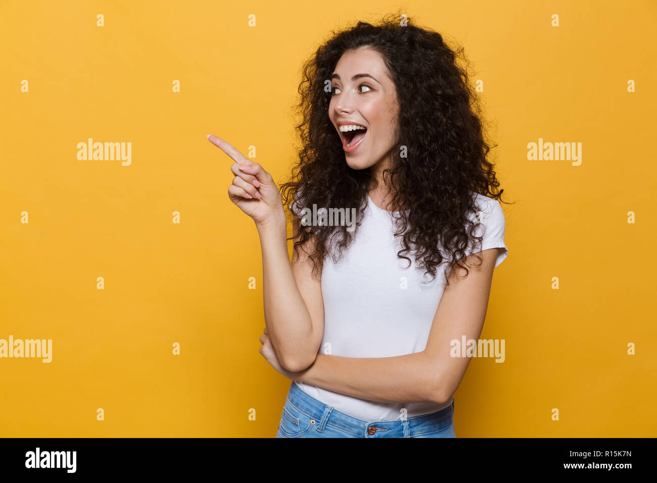 Photo of beautiful excited young cute woman posing isolated over yellow ...