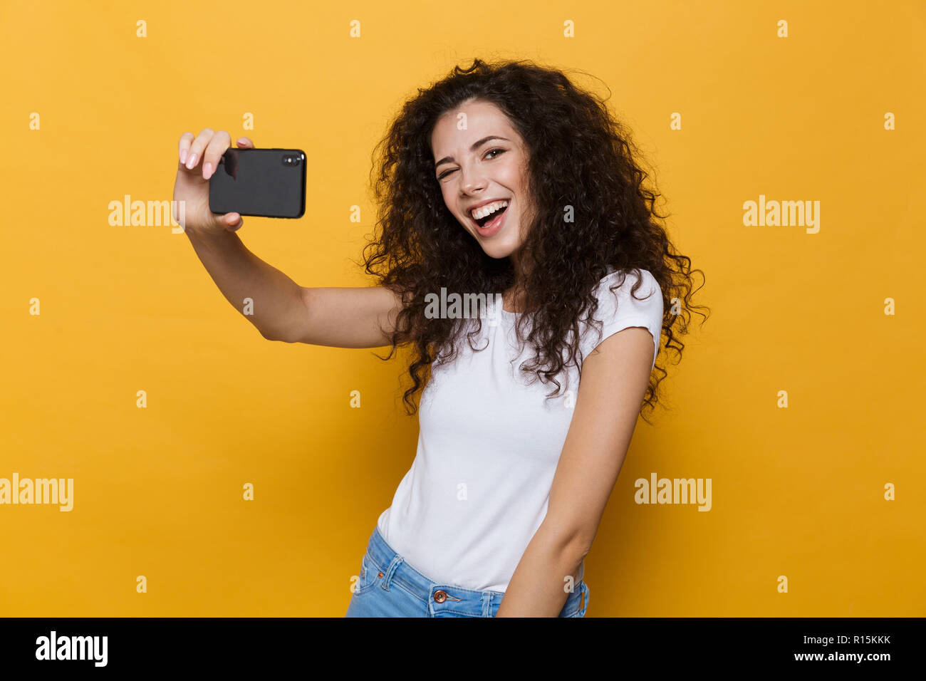 Image of an excited happy cute young woman posing isolated over yellow ...