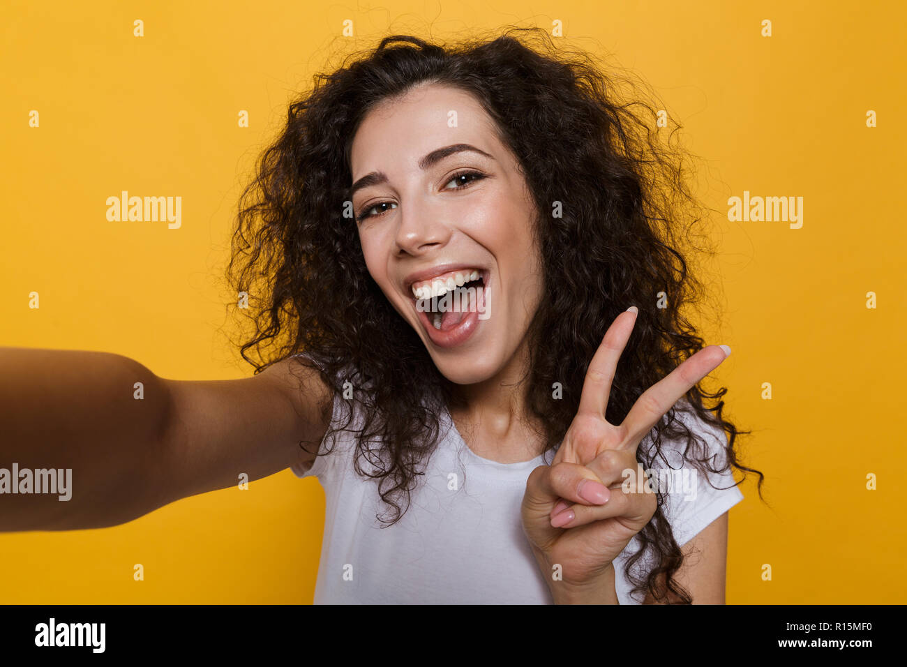 Image of an excited happy cute young woman posing isolated over yellow ...