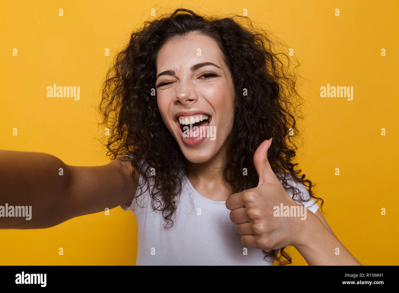 Image of an excited happy cute young woman posing isolated over yellow ...