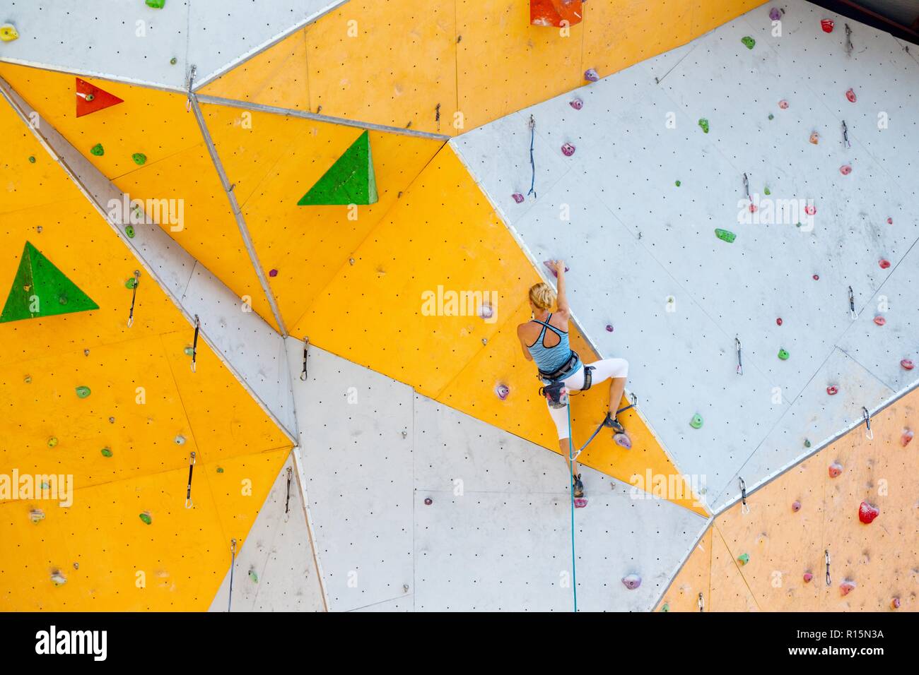 sport. bouldering girl climbing up the wall Stock Photo Alamy