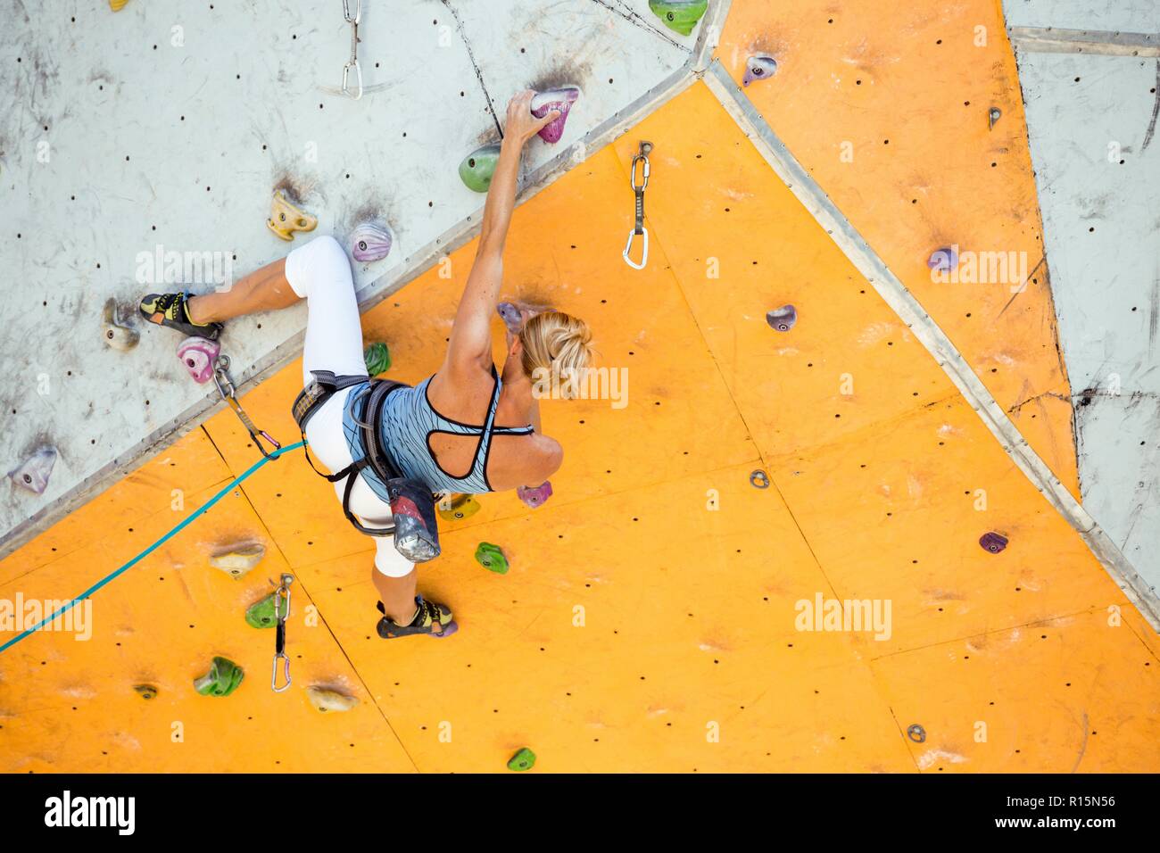 sport. bouldering girl climbing up the wall Stock Photo Alamy