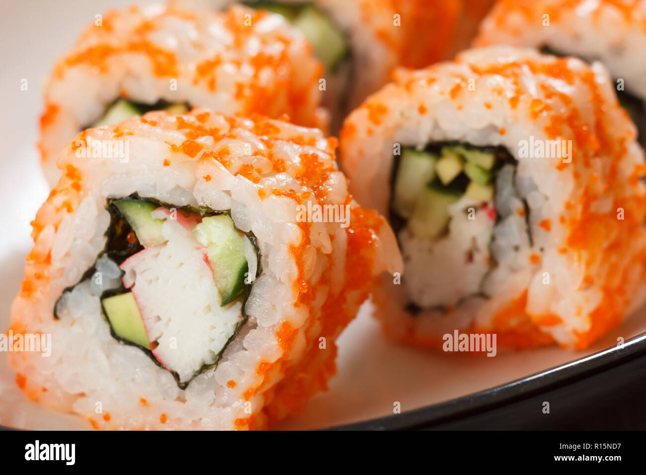 Close up Uramaki California. Sushi roll with nori, rice, pieces of ...