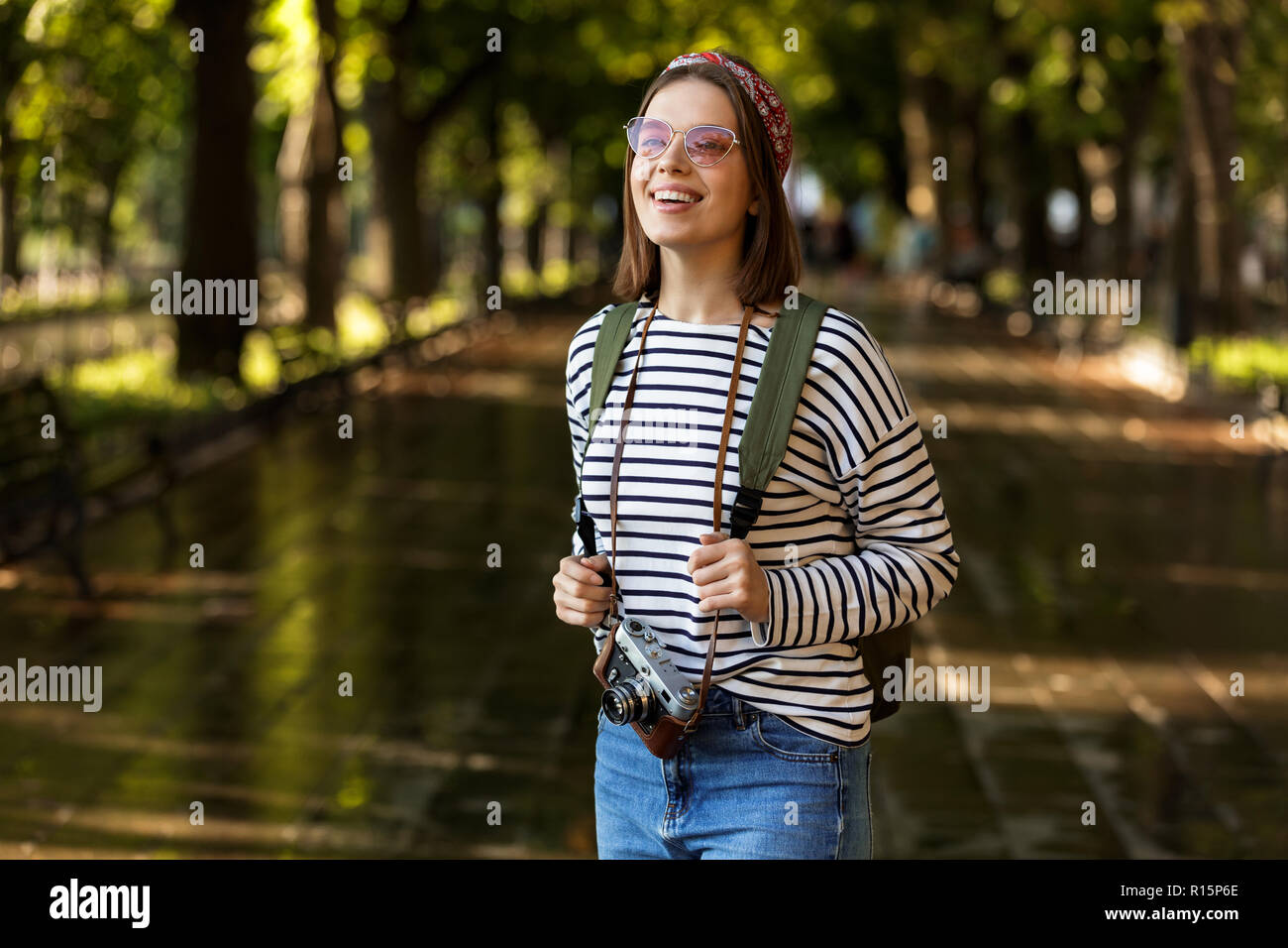 Image of excited beautiful young happy woman walking outdoors with ...