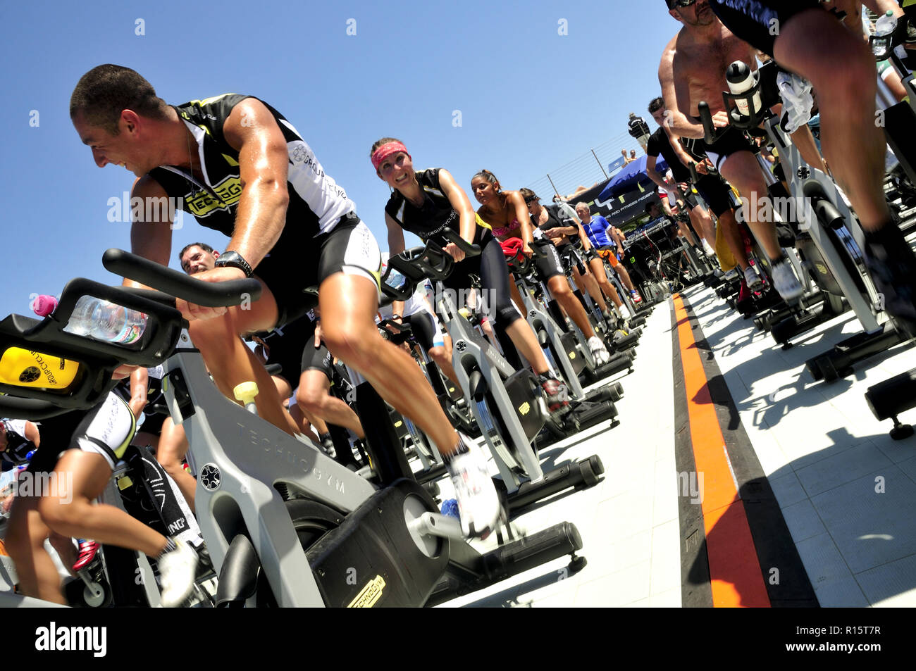 Group of people in a spinning outdoors class (female and male adults). Stock Photo