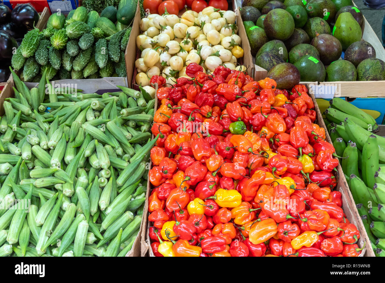 Mini bell peppers, pickles and peas for sale at a market Stock Photo