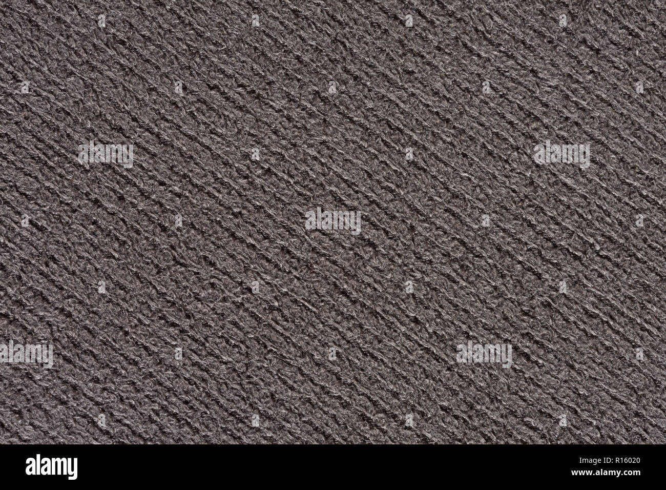 Strict grey textile background with relief surface. Stock Photo