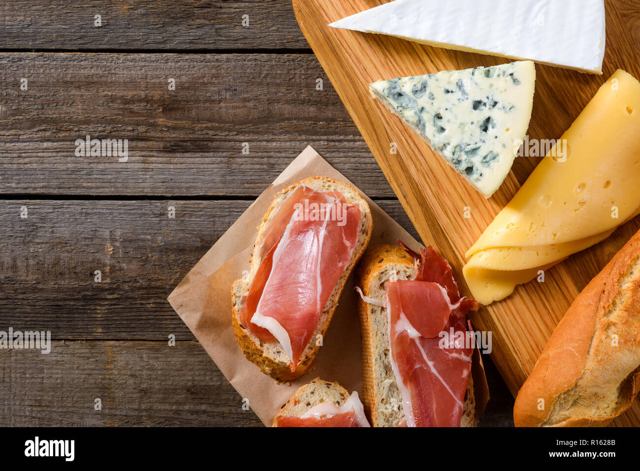 Cheese, bread and meat. Brie, Dorblu and Gouda are good addition Stock Photo