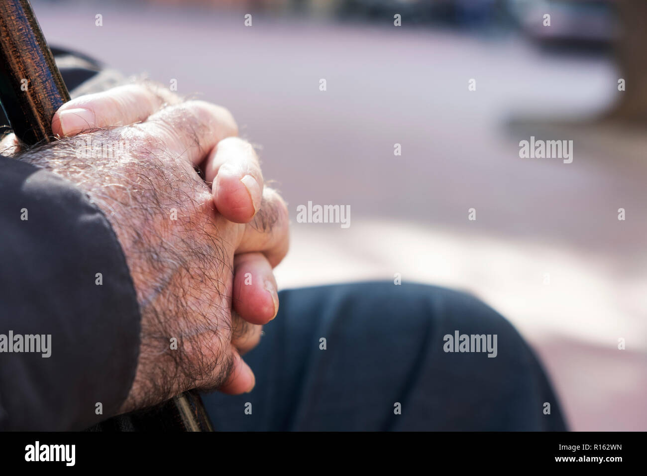closeup an old caucasian man outdoors with a walking stick in his hands Stock Photo