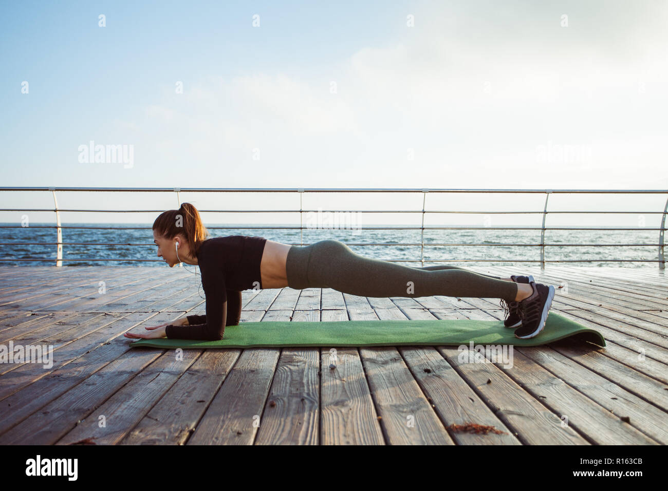 Fitness woman doing push ups Outdoor training workout Stock Photo