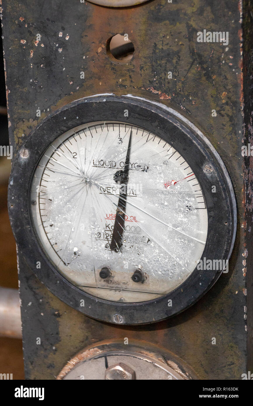 A close up view of a pressure gauge for Liquid Oxygen where the glass face has cracked and water of moisture has got into the main unit Stock Photo