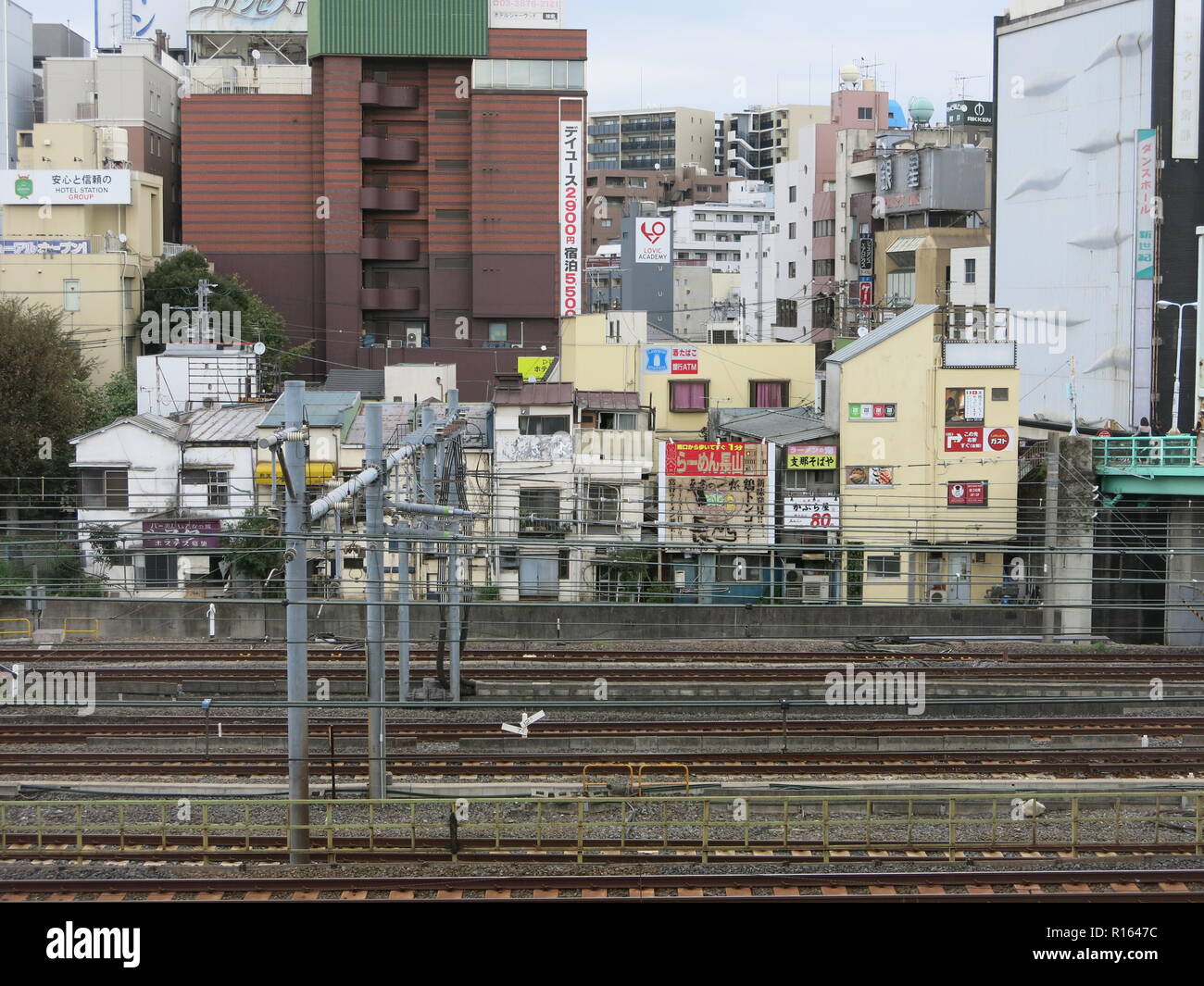 A view of central Tokyo from the window of a train on the Yamanote Line (JR East), Tokyo to Meguro: high density of buildings and railtracks; Japan Stock Photo
