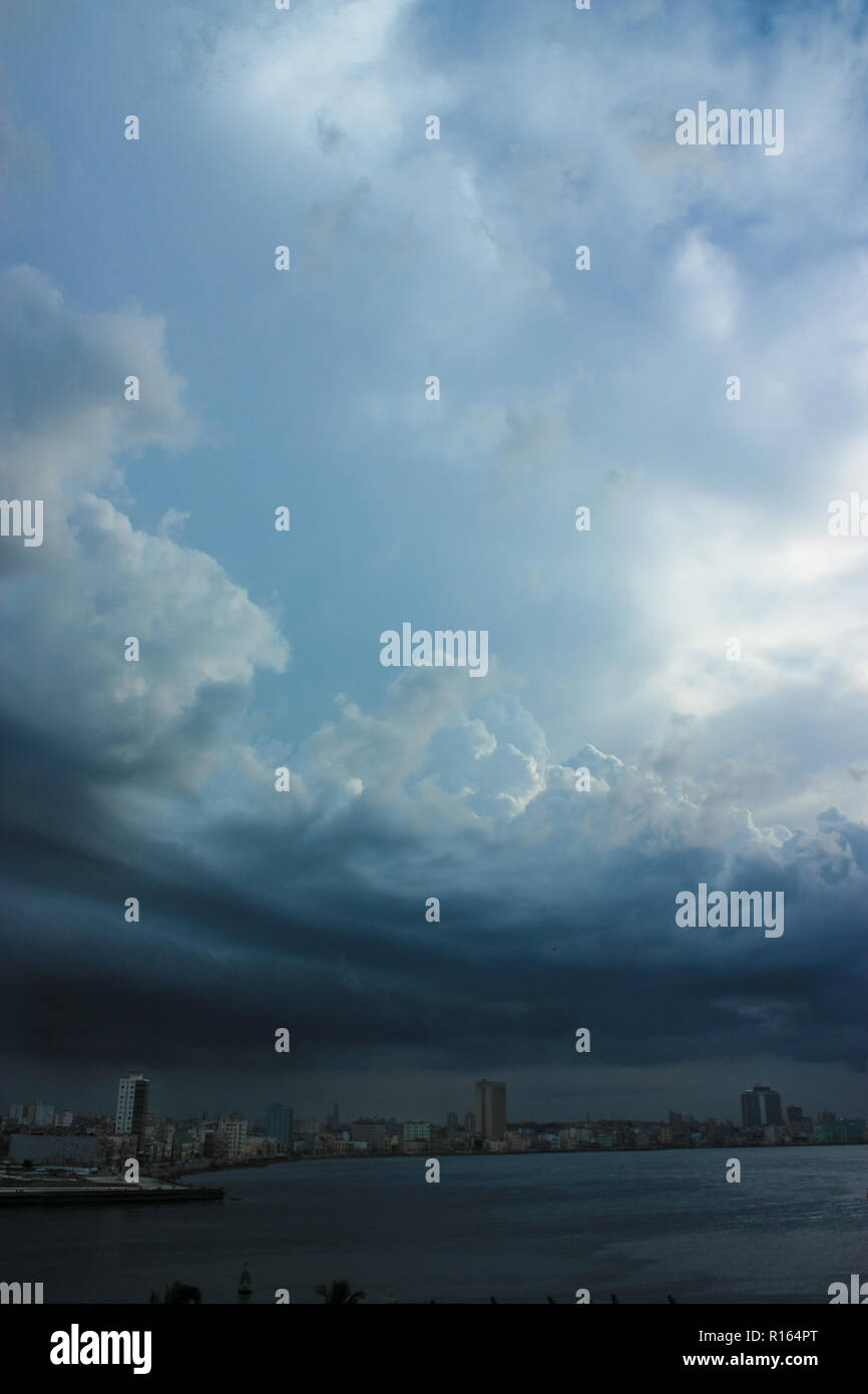 A hurricane is making its way on land in La Havana Cuba, creating a very oppressing scene with frightening lightening Stock Photo