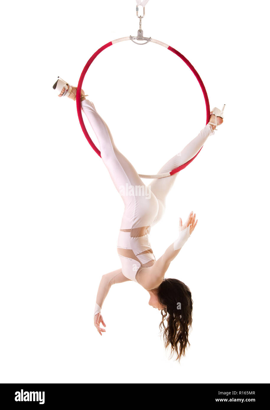 A young woman performs the acrobatic elements in the air ring. Studio ...