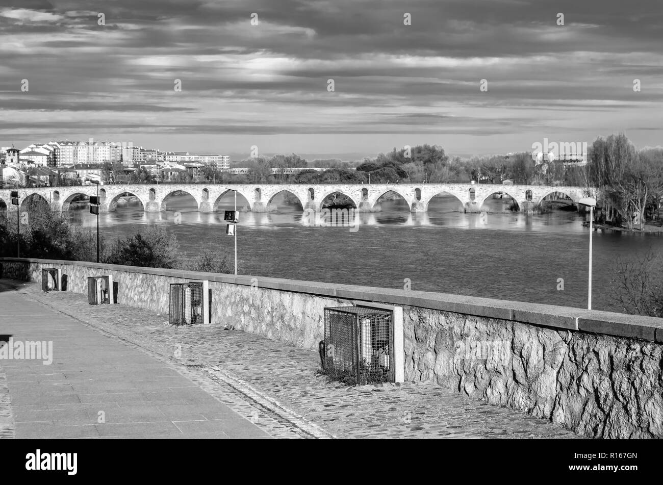 Old arch bridge over city river Black and White Stock Photos & Images ...