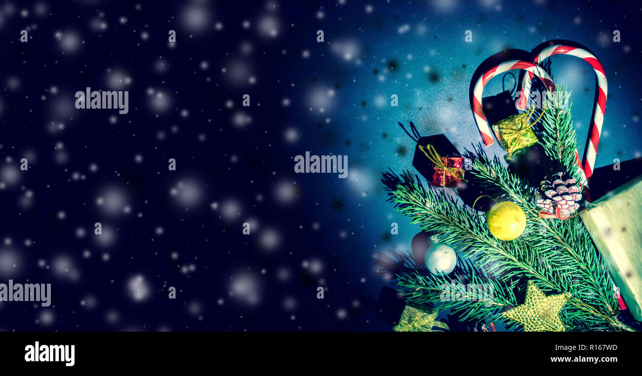 Branch of a Christmas tree with balls, fir cones, traditional candies ...