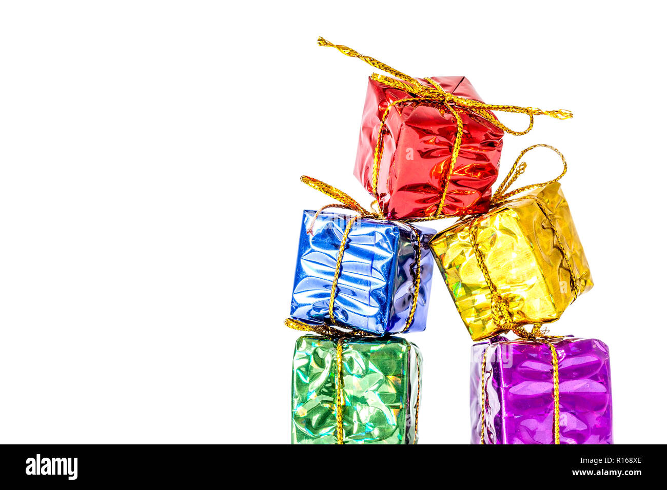 Gifts boxes in a multi-colored package bandaged with a bow stand in a ...