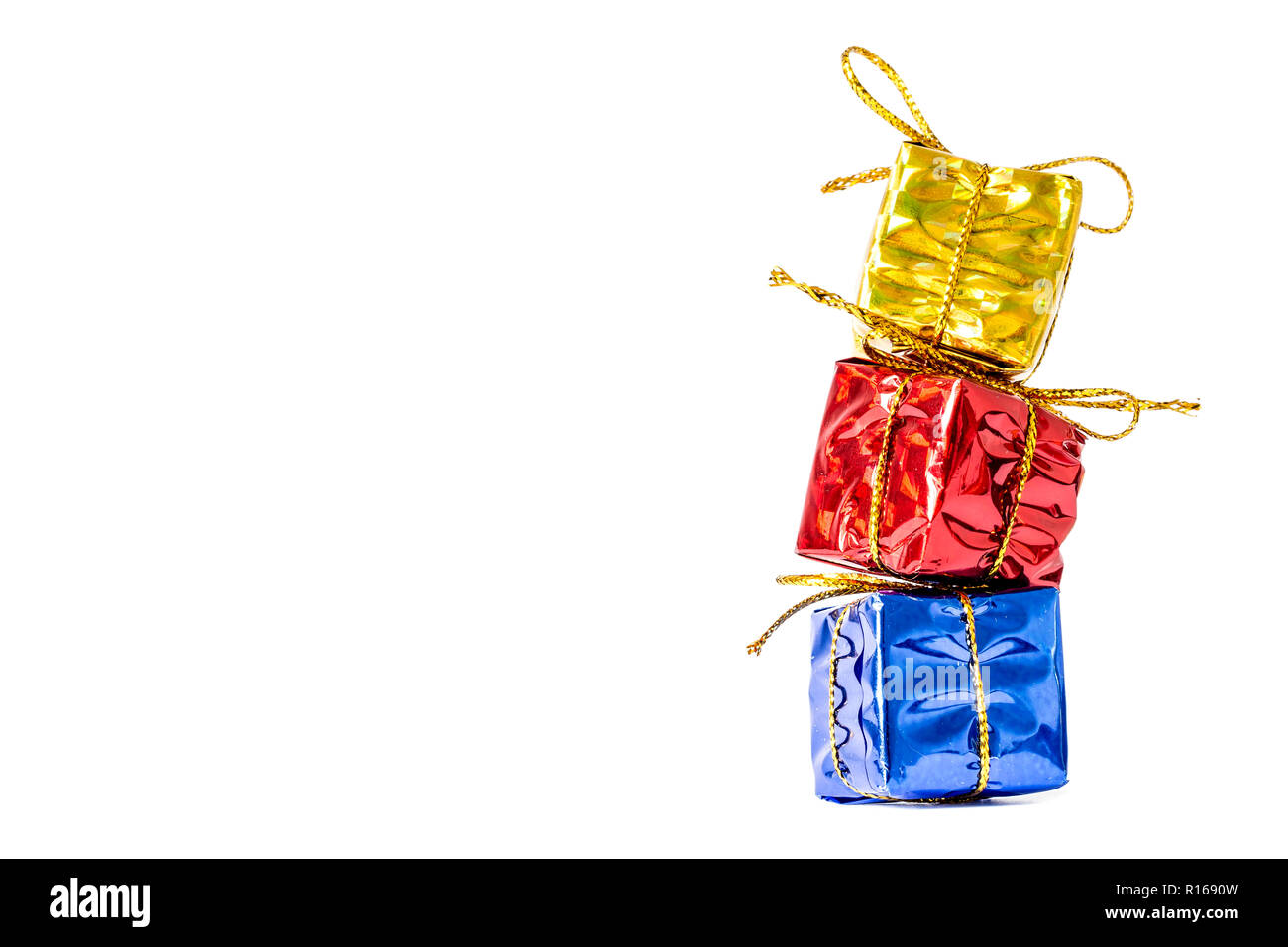 Gifts boxes in a multi-colored package bandaged with a bow stand in a ...