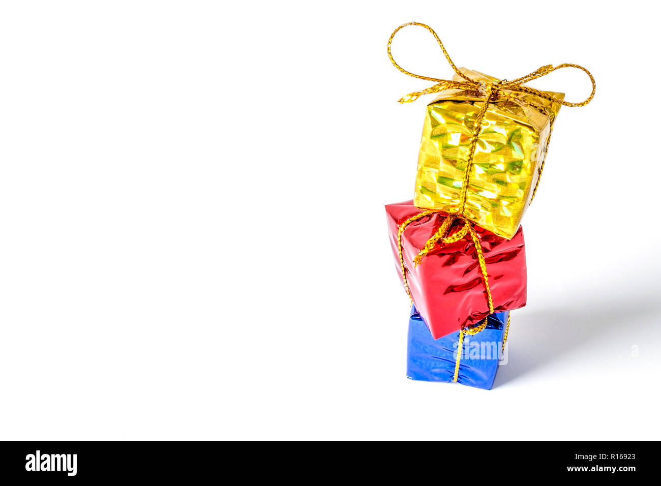 Gifts boxes in a multi-colored package bandaged with a bow stand in a ...