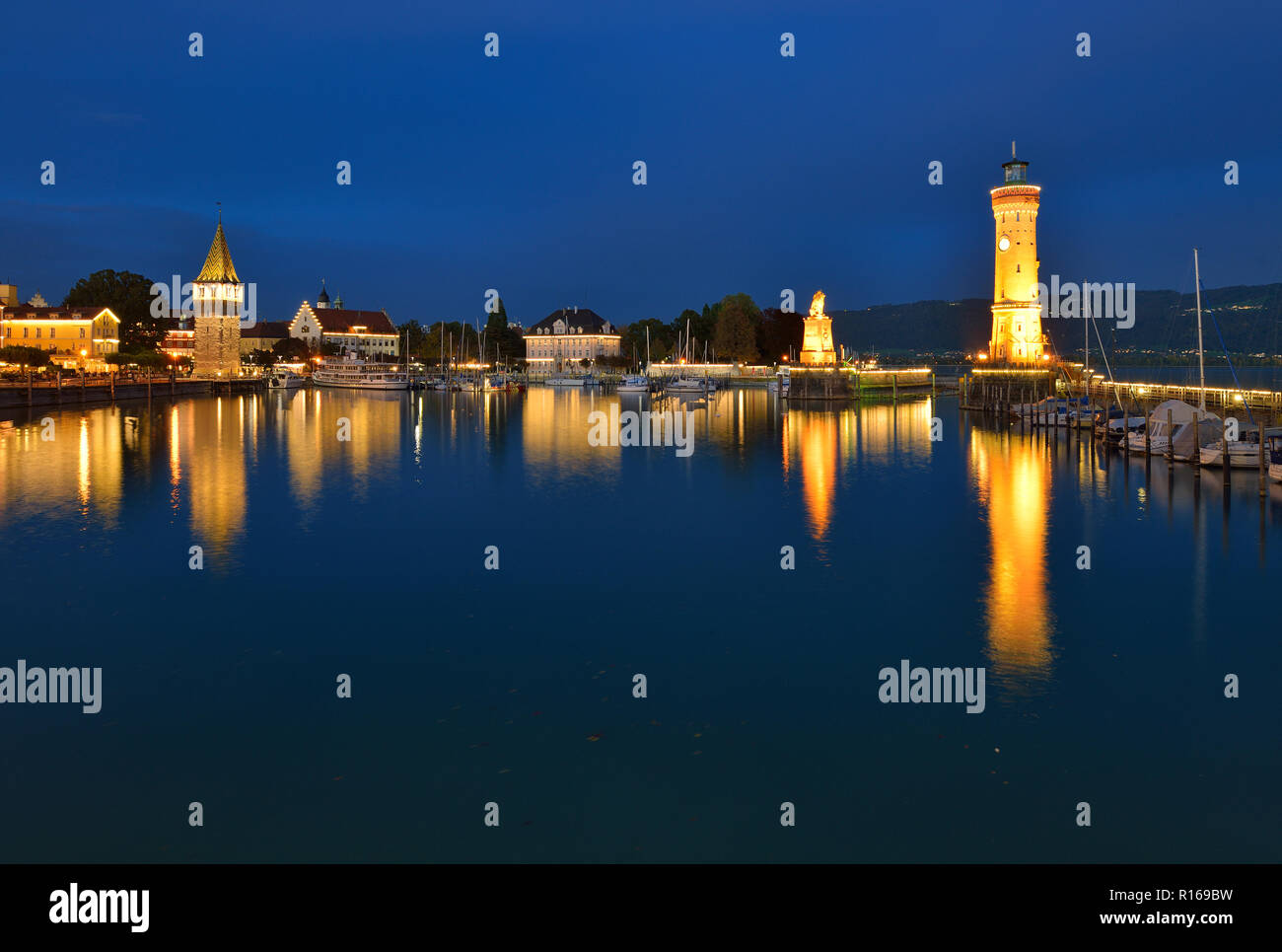Mangturm, Bavarian lion and lighthouse in the harbour, twilight, water reflection, Lindau, Lake Constance, Bavaria, Germany Stock Photo