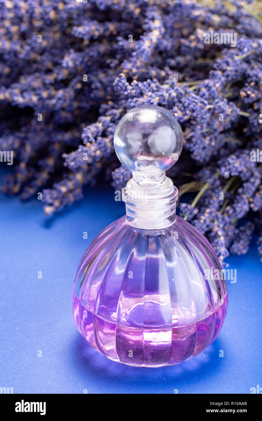 Natural healthy aromatherapy and home fragrance, purple lavender eccential  oil in glass decorative bottle and dried lavender flowers close up Stock  Photo - Alamy