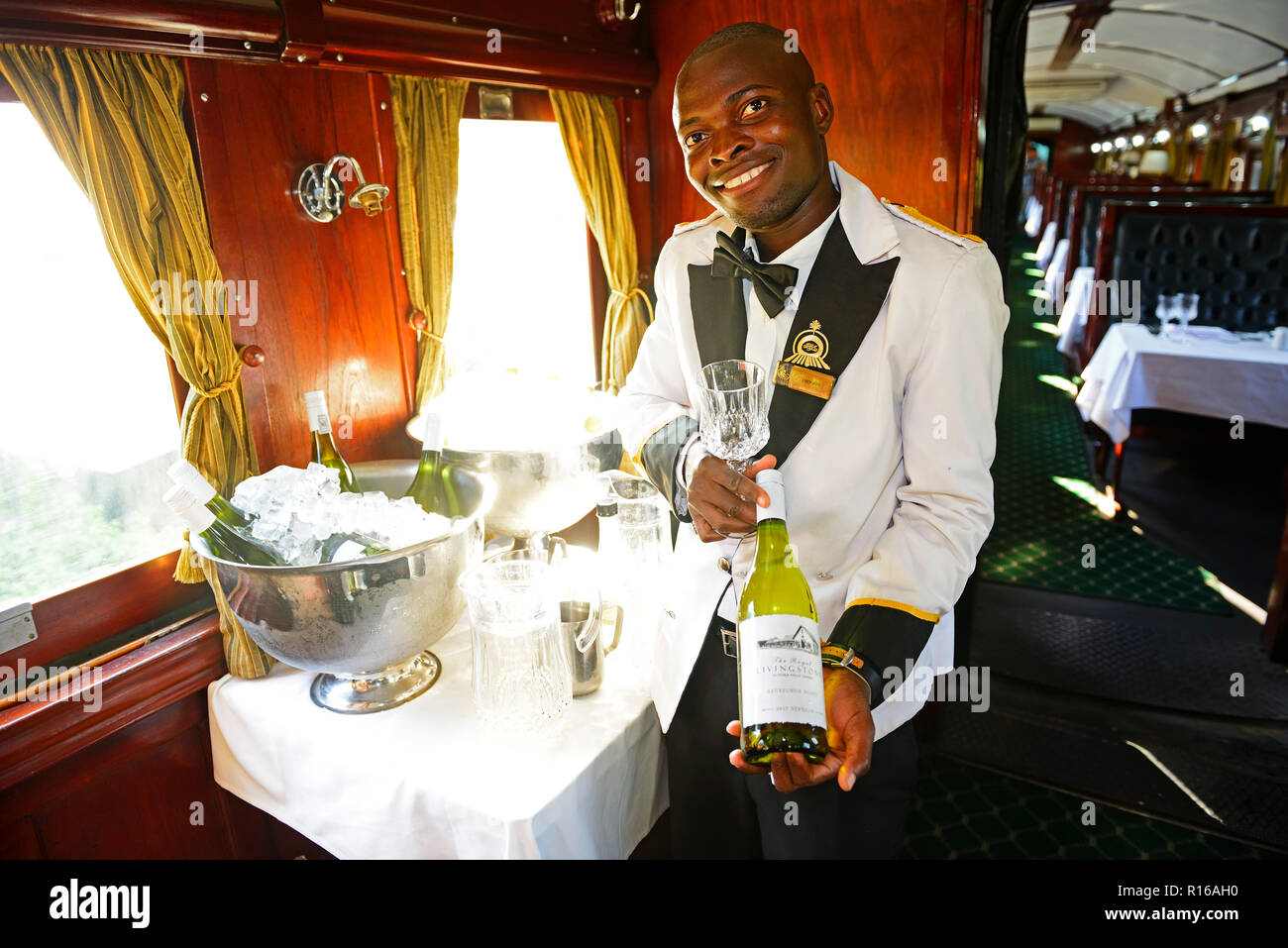Service staff with wine selection in luxury train, Royal Livingstone Express, Livingstone, Zambia Stock Photo