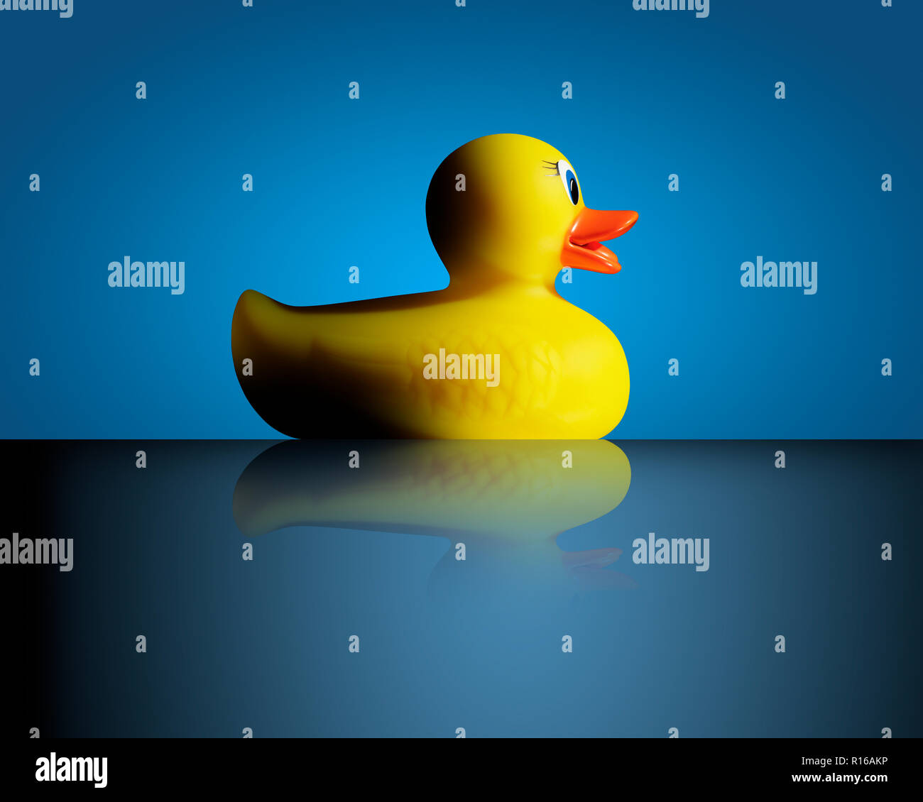Yellow rubber duck against blue background, side view Stock Photo