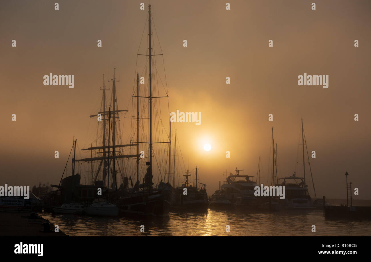 Ships silhouetted against dawn sky in Poole Stock Photo - Alamy