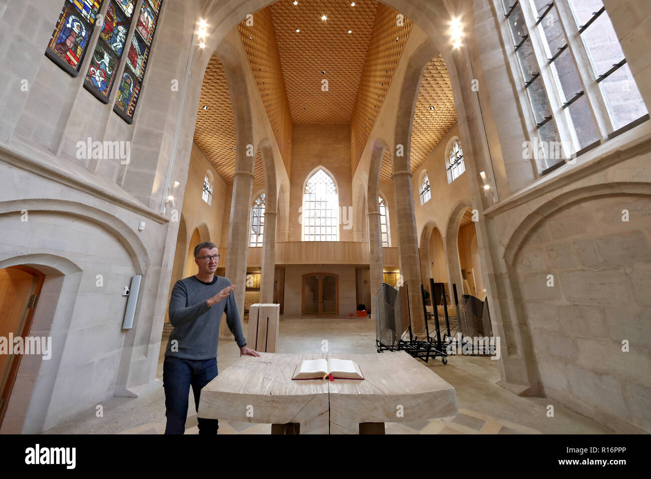 08 November 2018, Bavaria, Nürnberg: Georg Rieger, coordinator of the reconstruction of St. Martha's Church, stands at the Communion table in the renovated building. After a fire with damage running into millions in June 2014, the Nuremberg Church of St. Martha reopens on 10 November. During the fire, the roof of the main nave was completely burnt down and parts of the building were in danger of collapsing. Photo: Daniel Karmann/dpa Stock Photo
