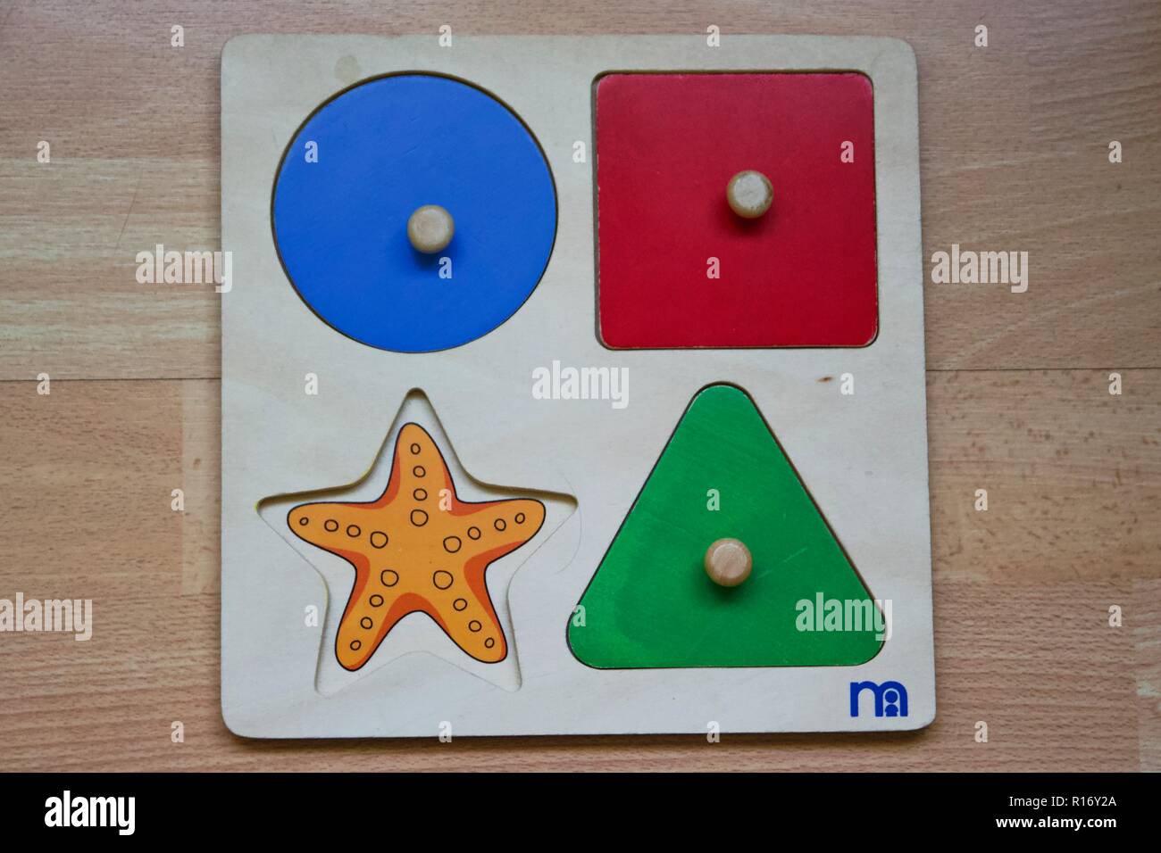 A Mothercare wooden puzzle toy with one missing piece / missing part Stock Photo