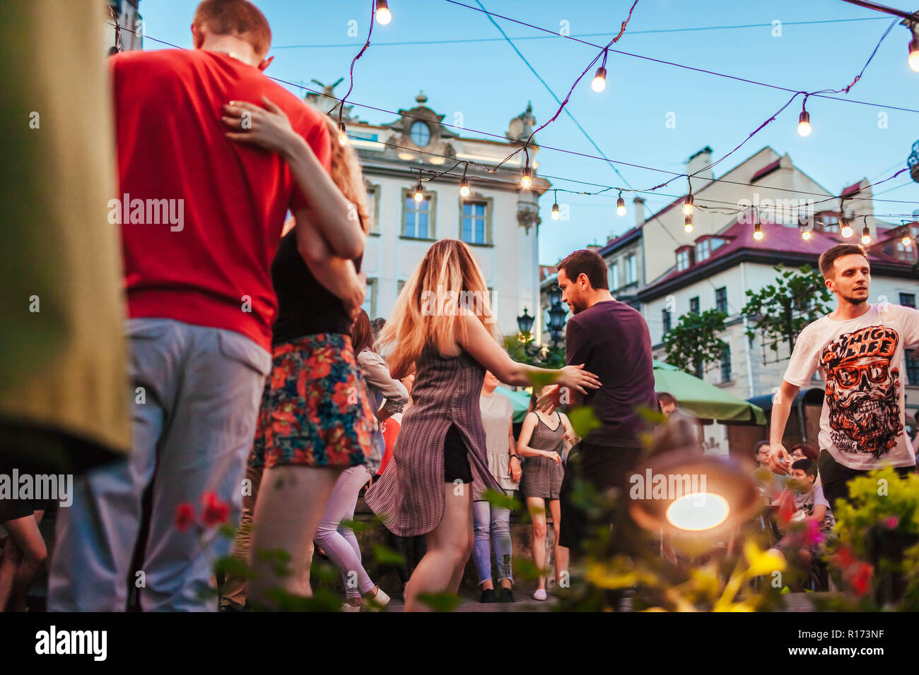 Lviv, Ukraine - June 9, 2018. People dancing salsa and bachata in outdoor cafe by Diana in Lviv Stock Photo