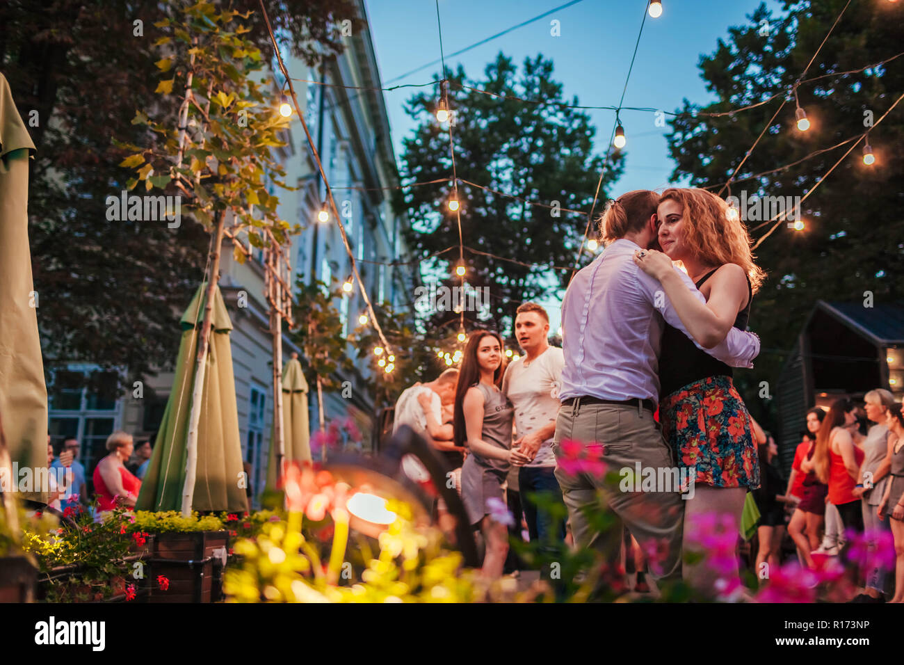 Lviv, Ukraine - June 9, 2018. People dancing salsa and bachata in outdoor cafe by Diana in Lviv Stock Photo