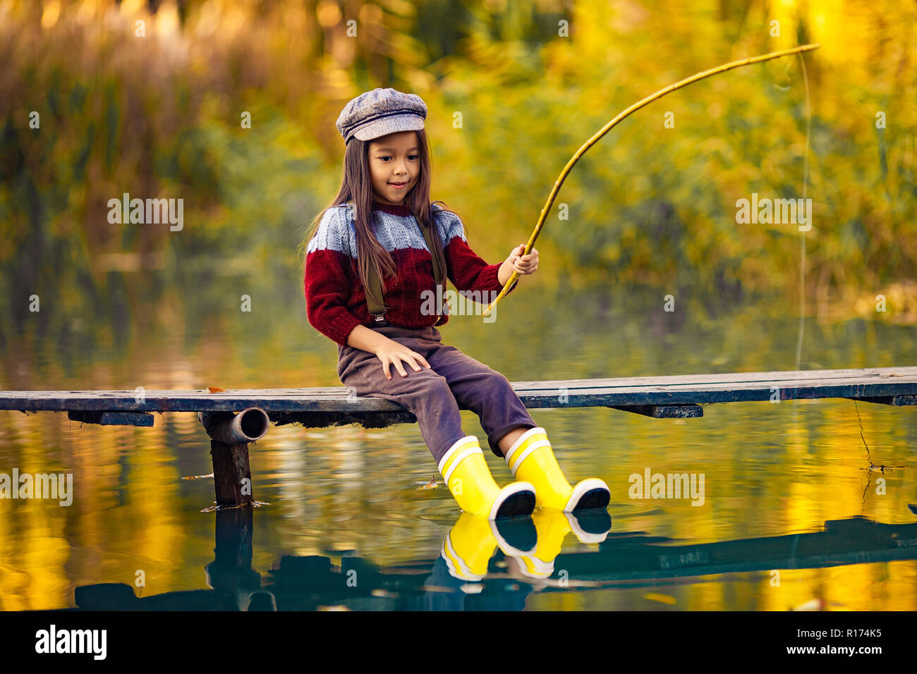 Girl with rod and small fish hi-res stock photography and images