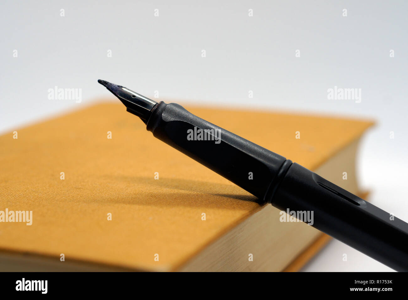 black pen at brown hard covered book Stock Photo