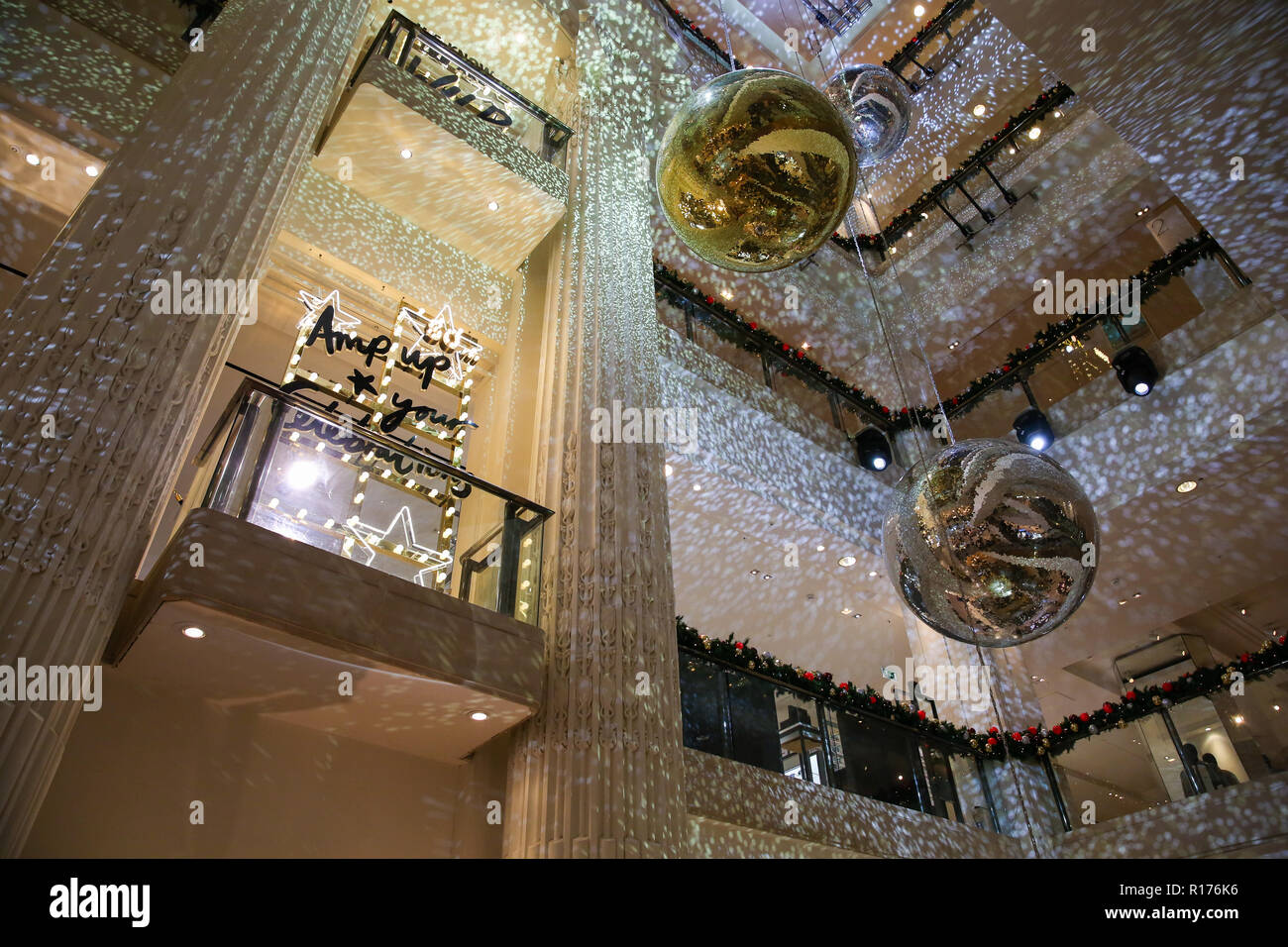 Interior view of Selfridges. Selfridges on Oxford Street, London is decorated with large glitter balls and Christmas lights for the festive season. Stock Photo