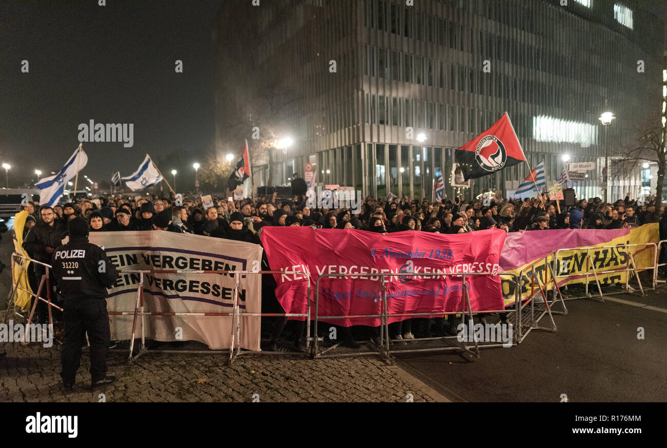 Protesters are seen holding banners and flags during the protest. Hundreds of people have demonstrated against the funeral march of the right-wing extremist organization on the 80th anniversary of the Pogrom Night in 1938 under the motto 'Funeral March for the Dead of Politics'. Stock Photo