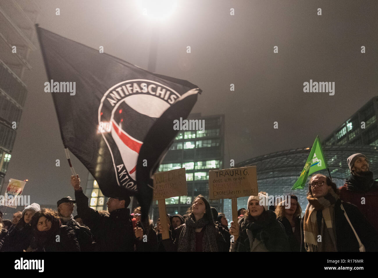 Protesters are seen holding placards and flags during the protest. Hundreds of people have demonstrated against the funeral march of the right-wing extremist organization on the 80th anniversary of the Pogrom Night in 1938 under the motto 'Funeral March for the Dead of Politics'. Stock Photo