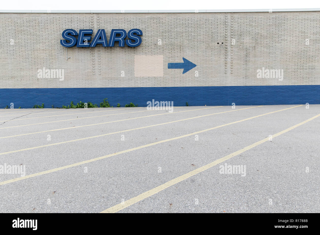 A logo sign outside of Sears retail store in Livonia, Michigan on