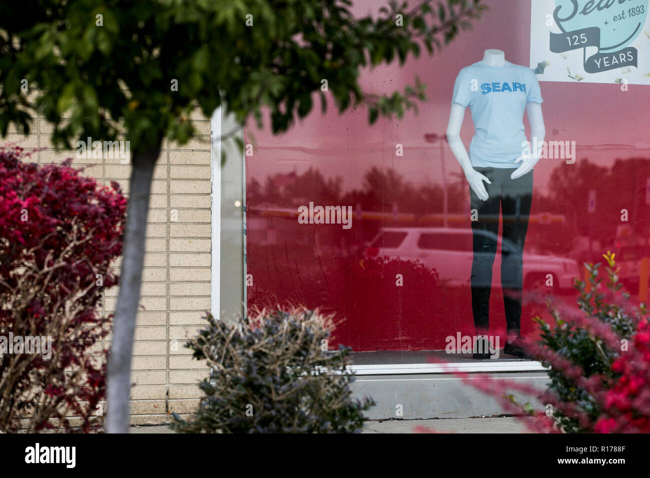 A logo sign outside of Sears retail store in Livonia, Michigan on