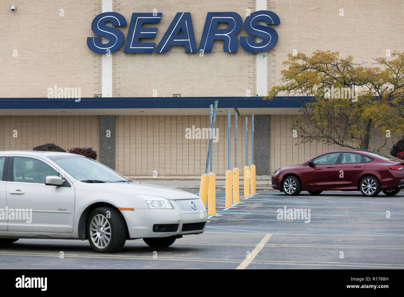 A logo sign outside of Sears retail store in Livonia, Michigan on