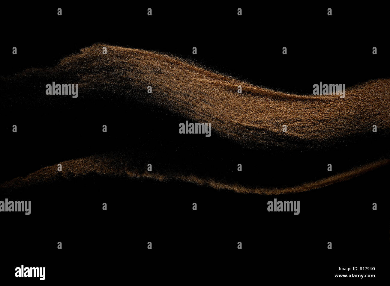 Sandy wave isolated on black background. Abstract sand dune. Stock Photo