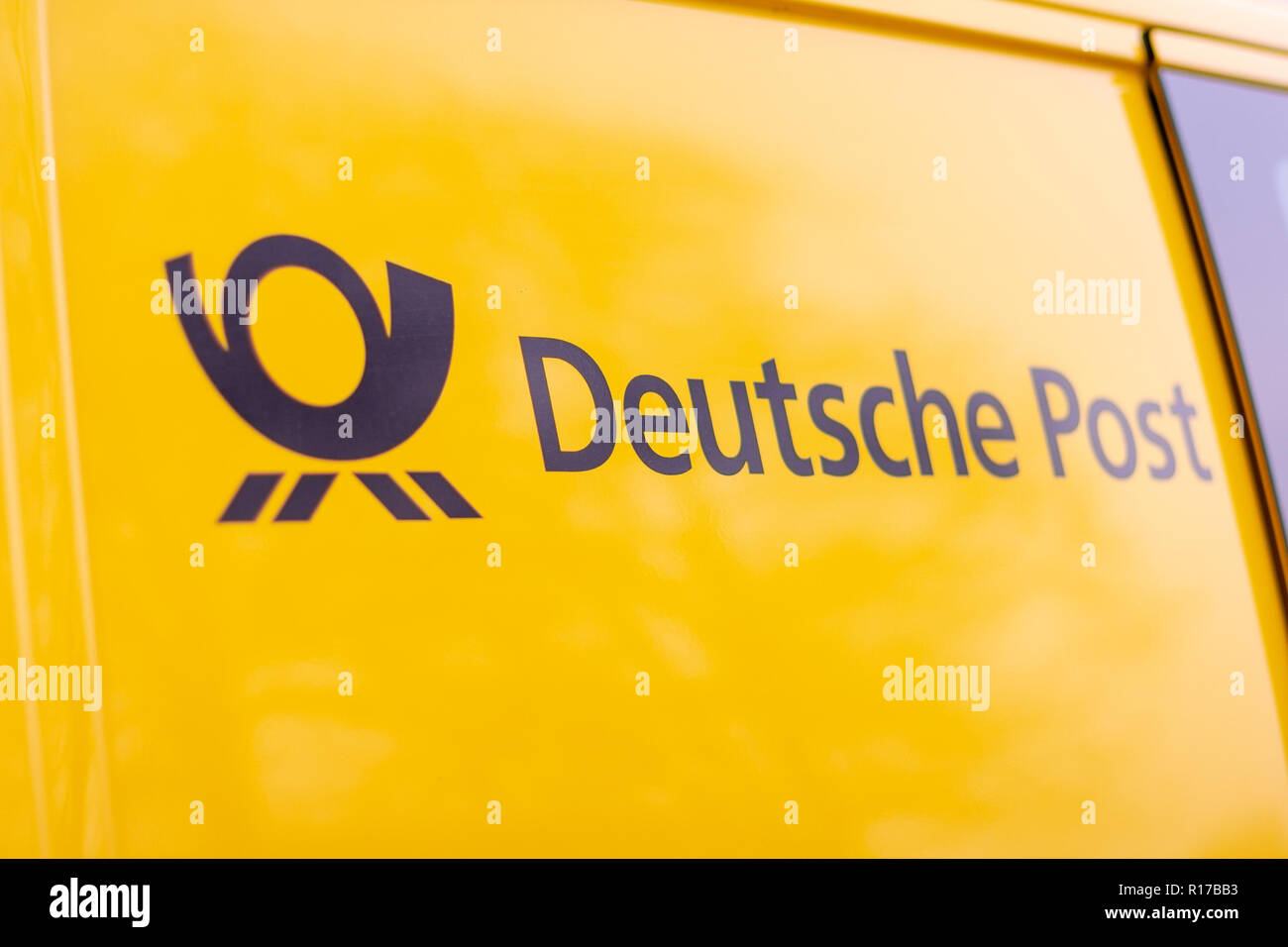 BERLIN / GERMANY - NOVEMBER 9,2018: Logo from Deutsche Post and DHL on yellow postcar. Stock Photo